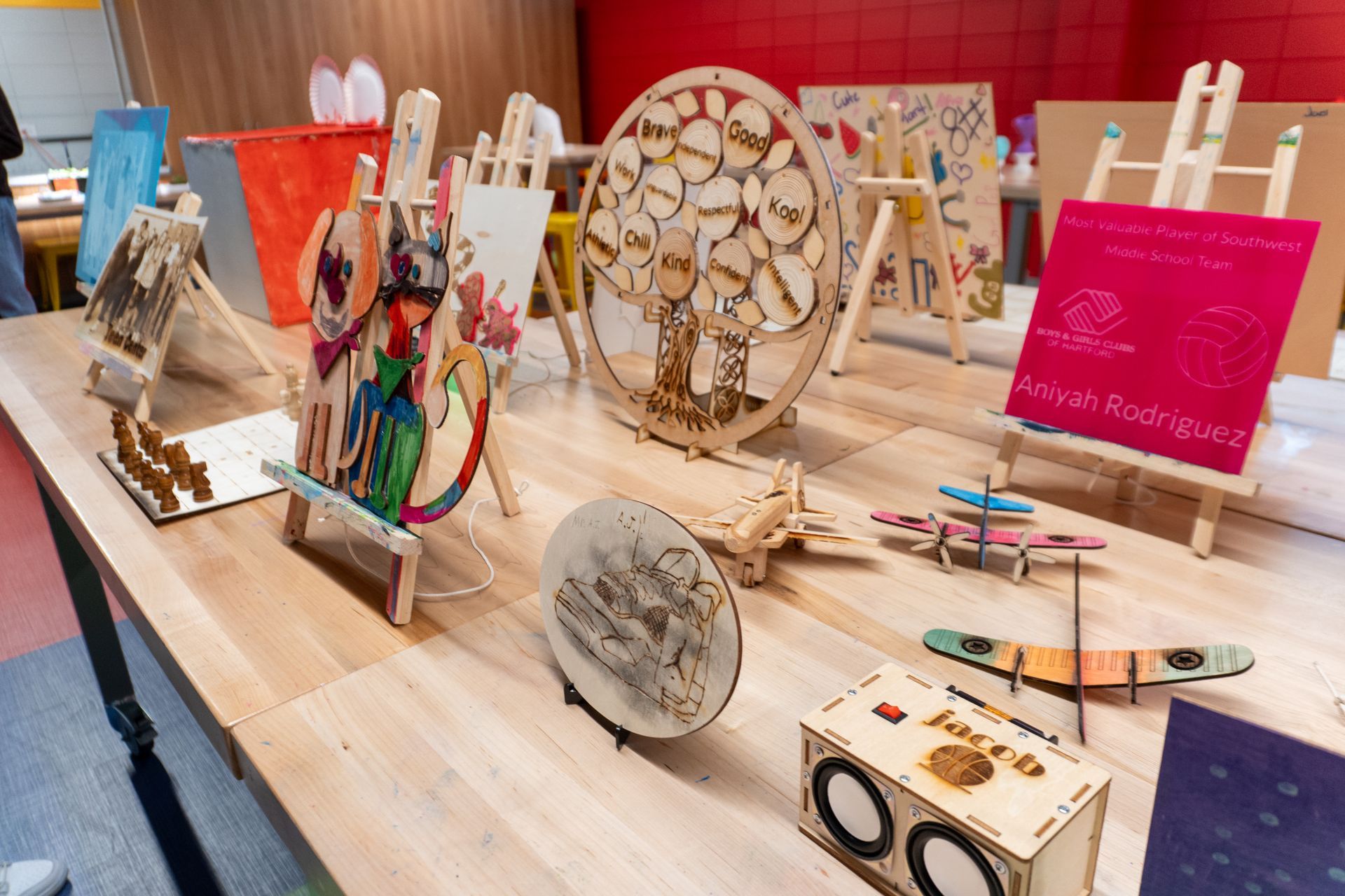 A wooden table with a variety of wooden crafts on it.