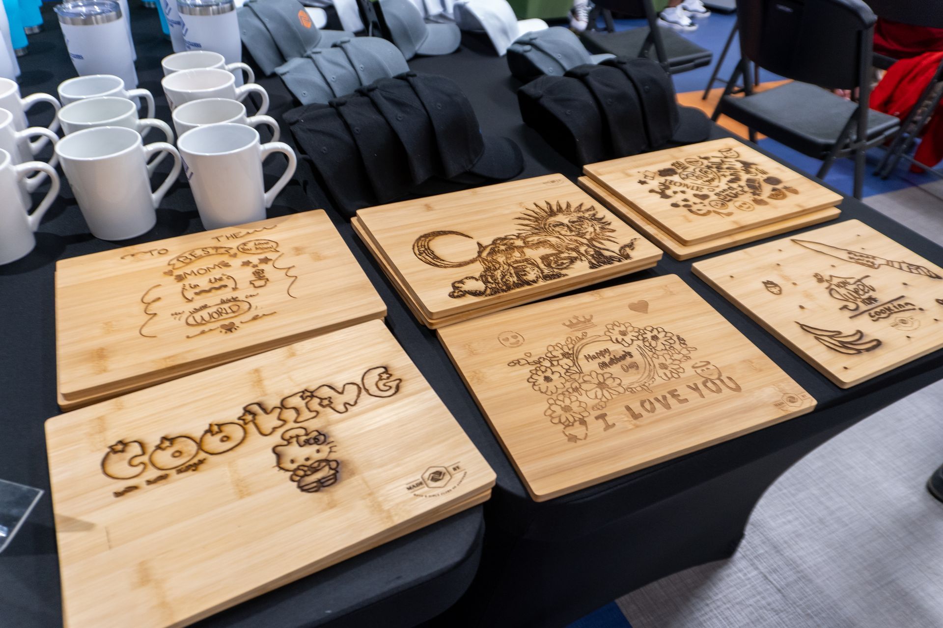A table with a bunch of wooden cutting boards on it.