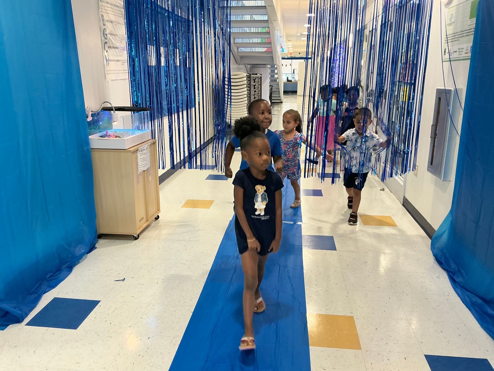 A group of children in a decorated hallway