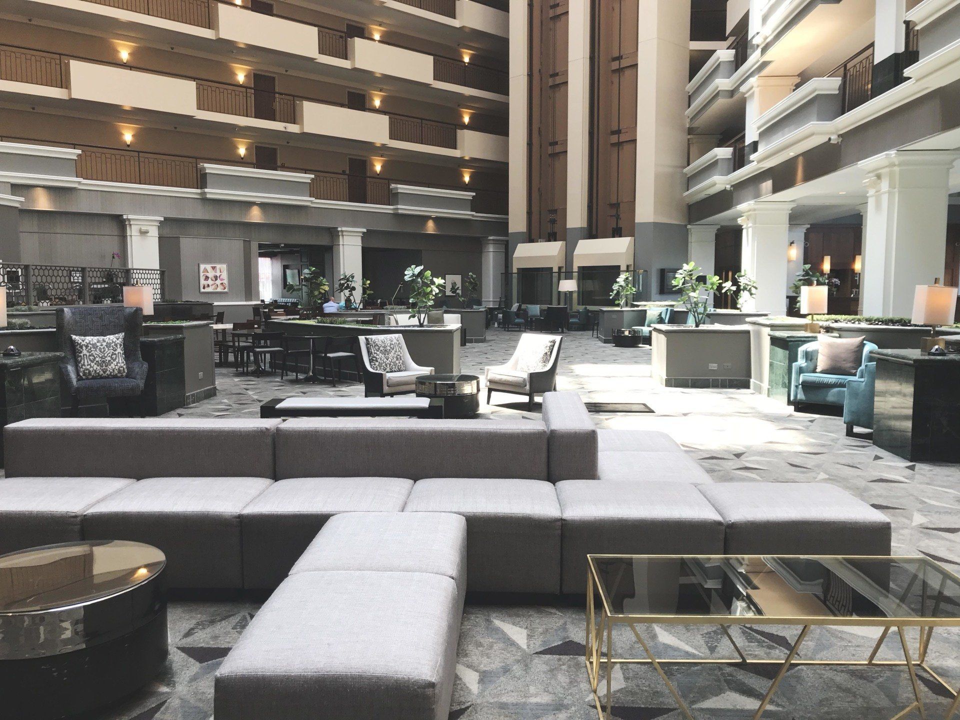 A large lobby of a hotel with a lot of furniture.