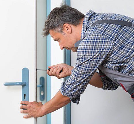 Man Fixing the Door Lock — Durham, NH — H & H Locksmith
