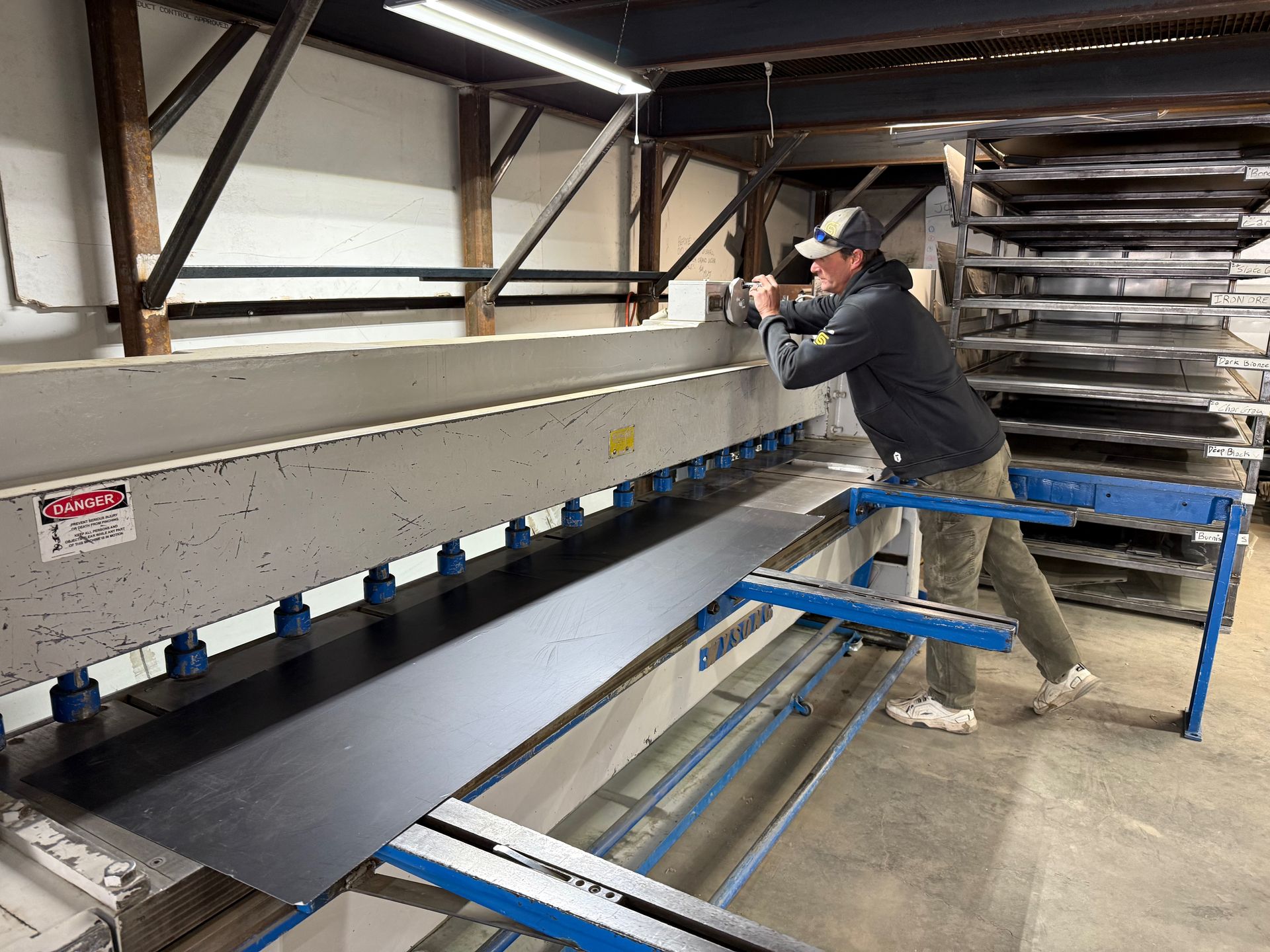 A man is working on a machine in a factory.