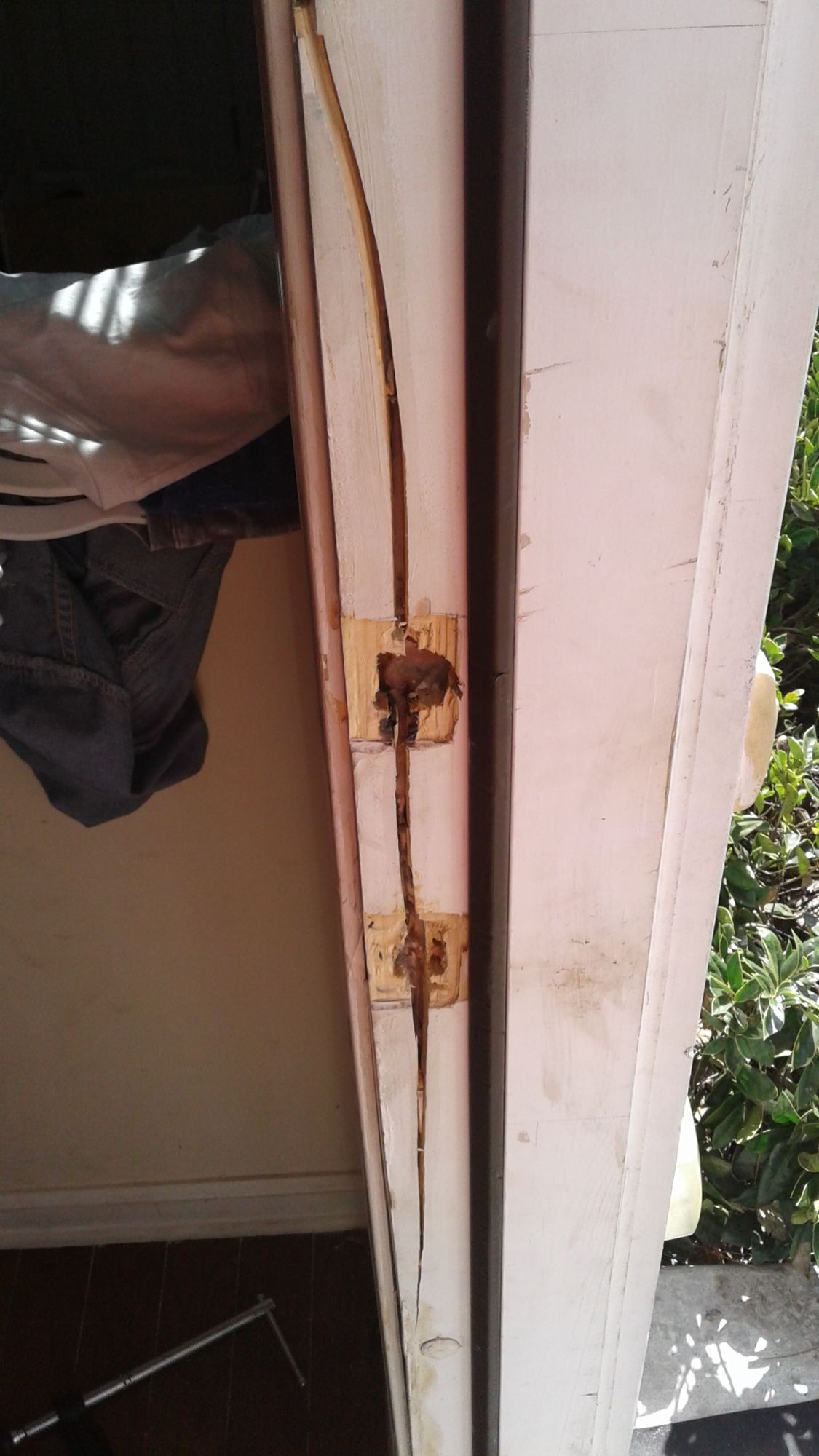 A close up of a door with a hole in it.