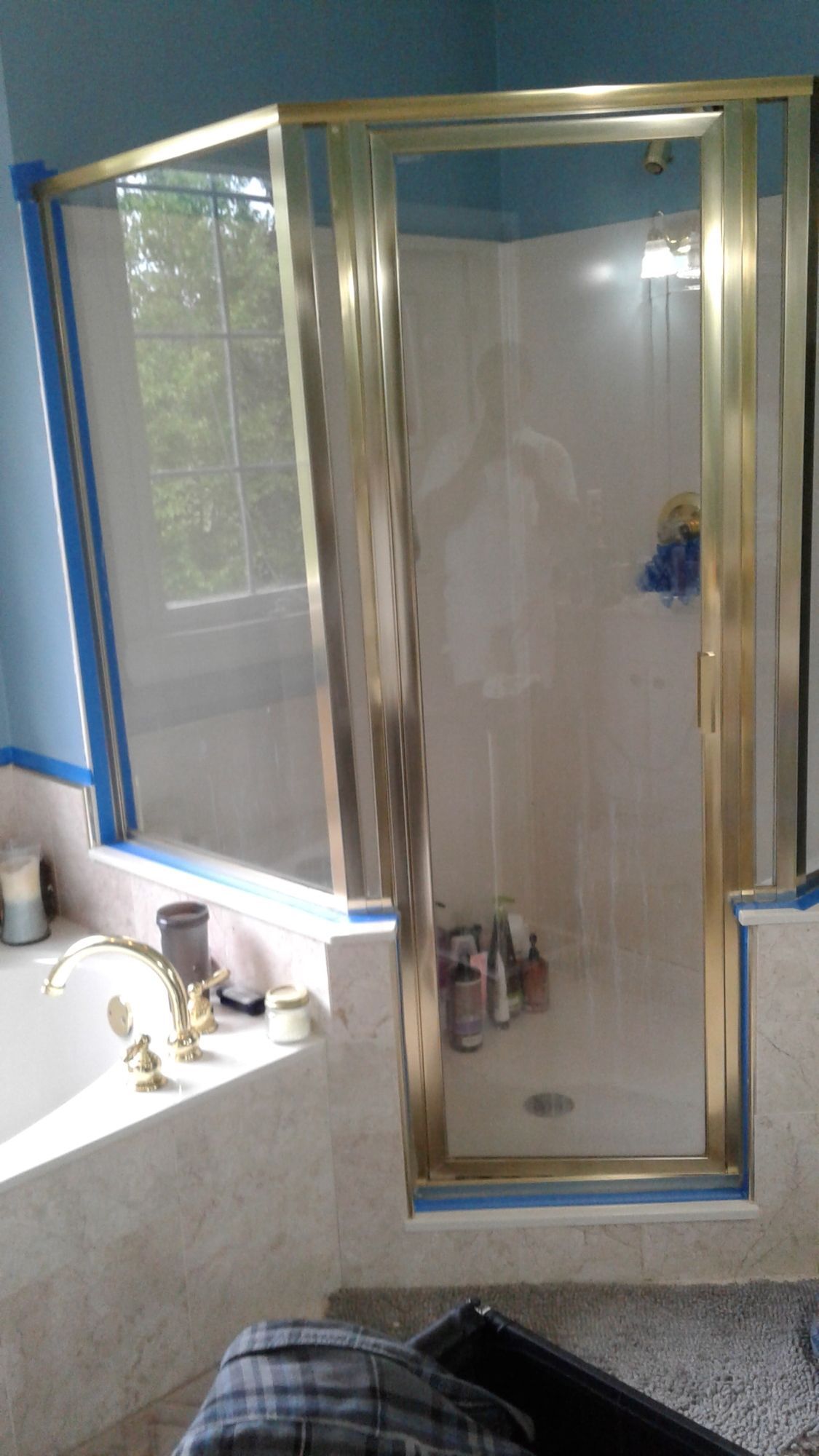 A bathroom with a bathtub and a shower stall.