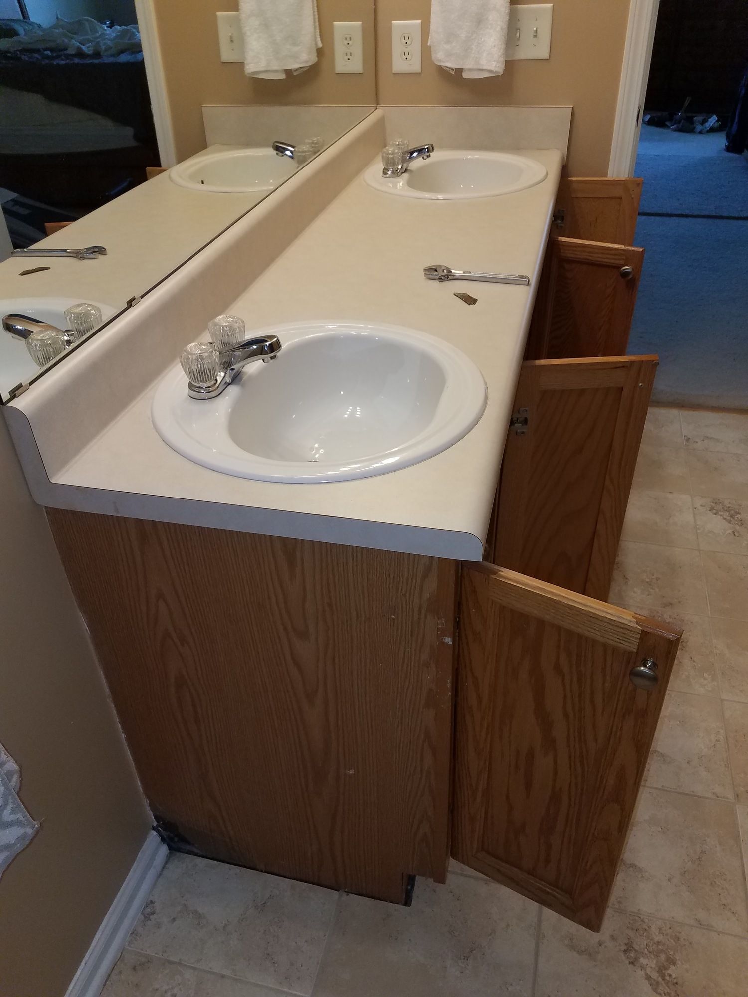 A bathroom vanity with two sinks and a mirror.