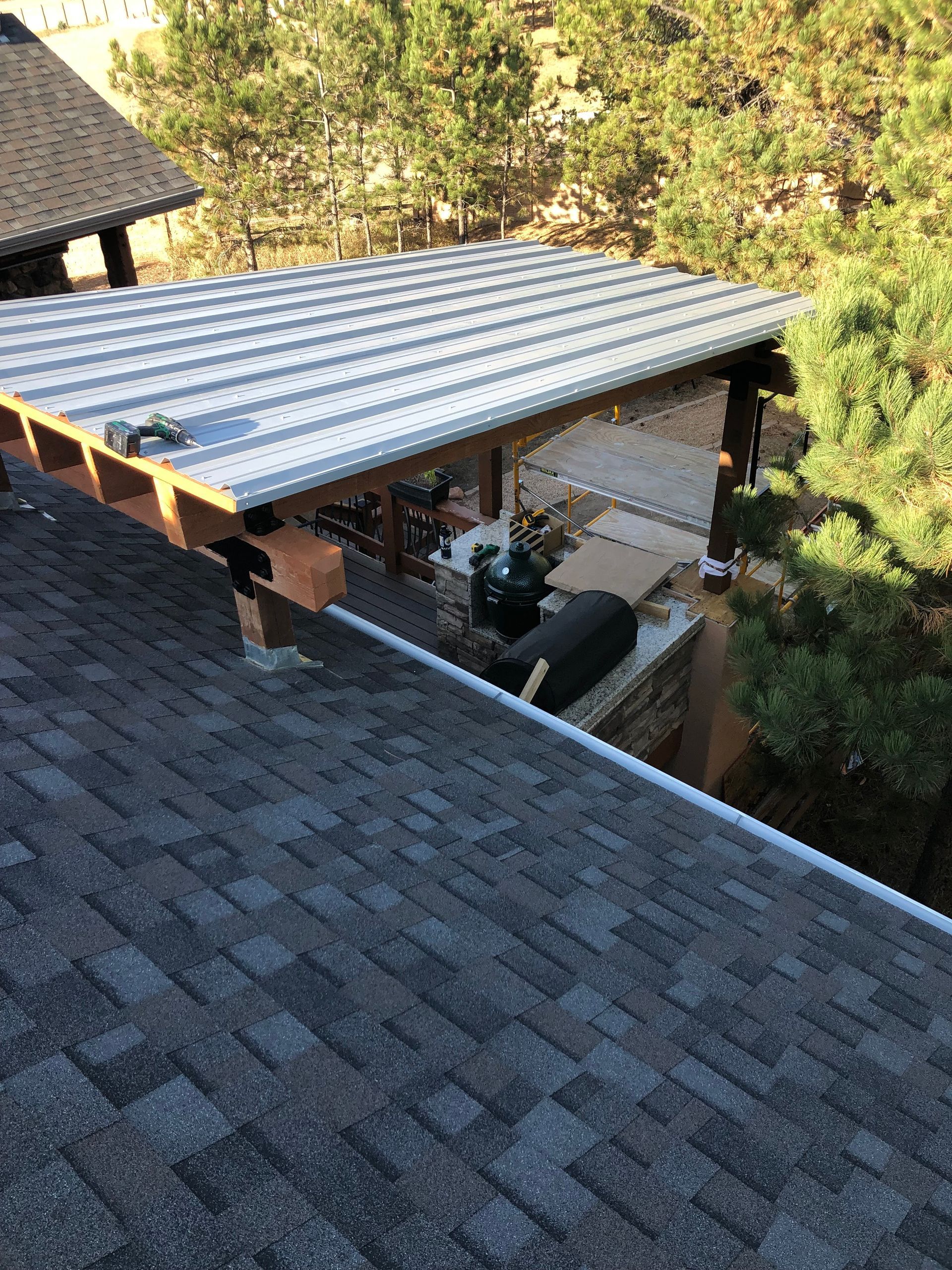 A roof with a metal roof is being built on top of a house.