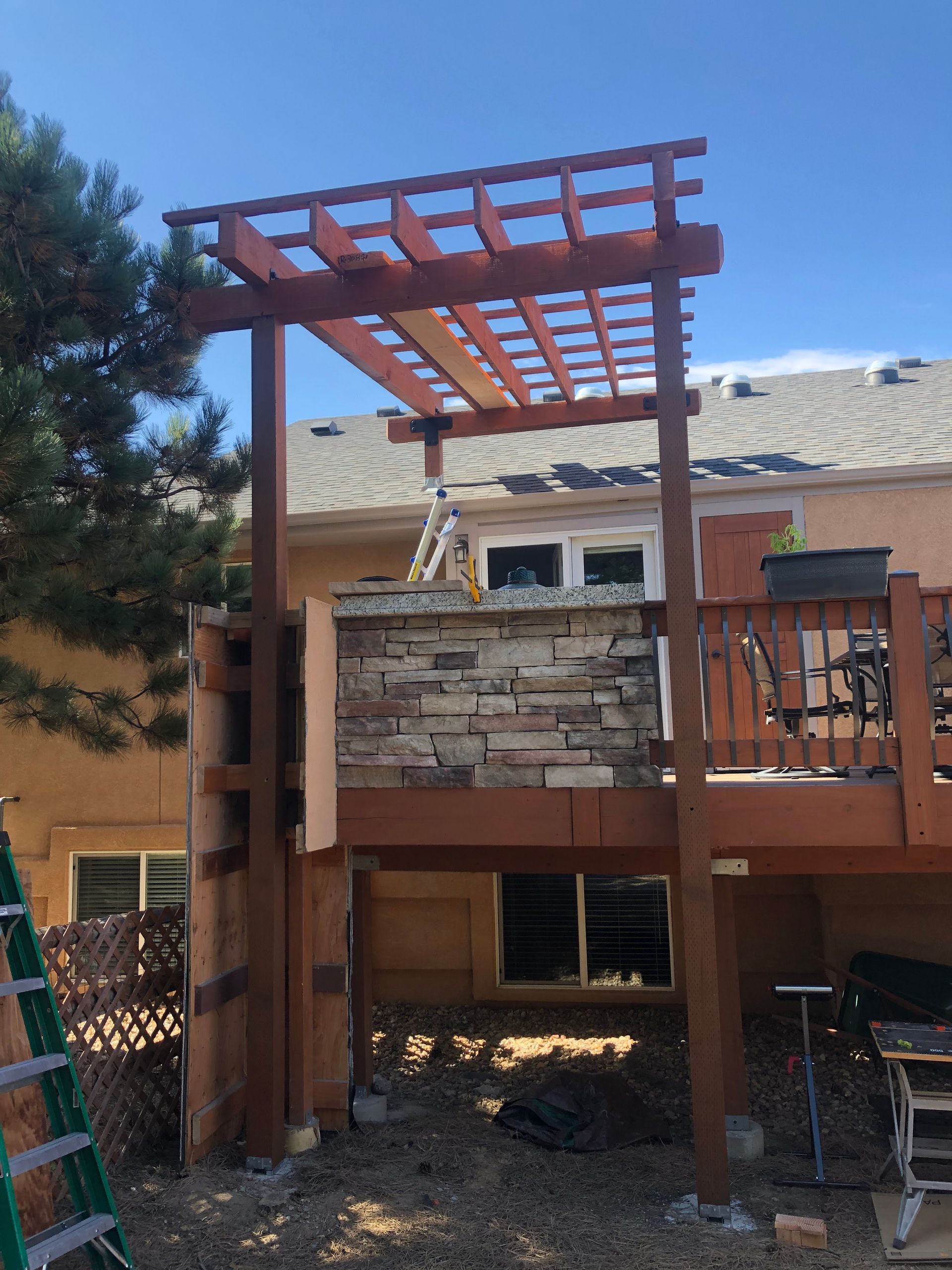A wooden pergola is being built on top of a deck