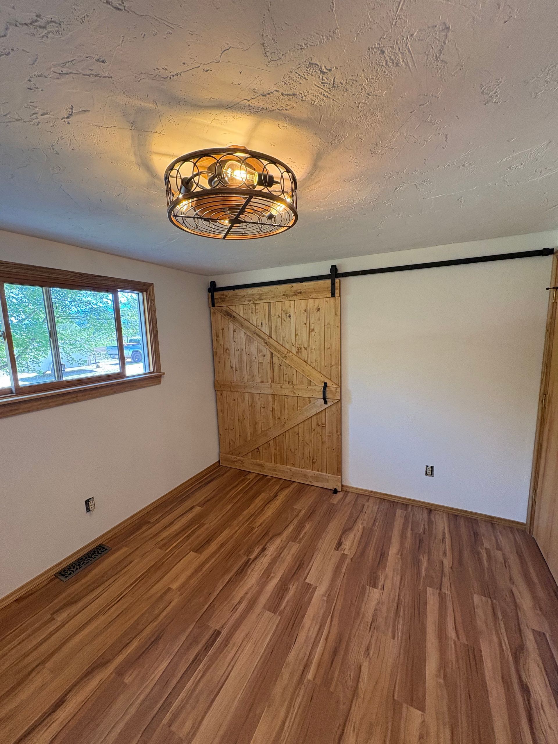 A chimney is sitting on the side of a brick building.