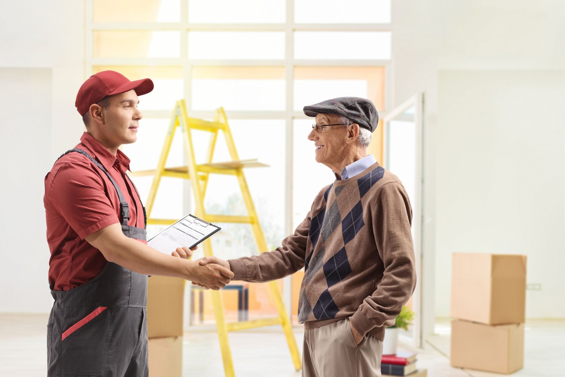 A man is shaking hands with an older man in a living room.