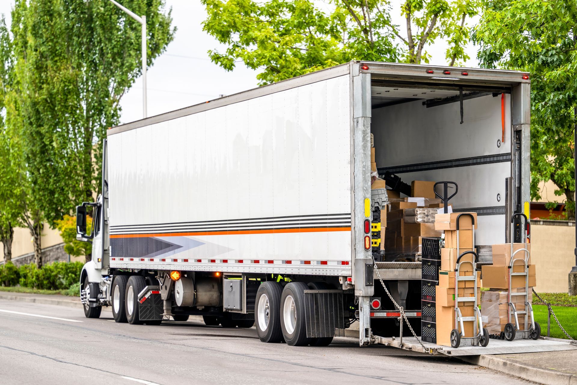 A moving truck is parked on the side of the road.