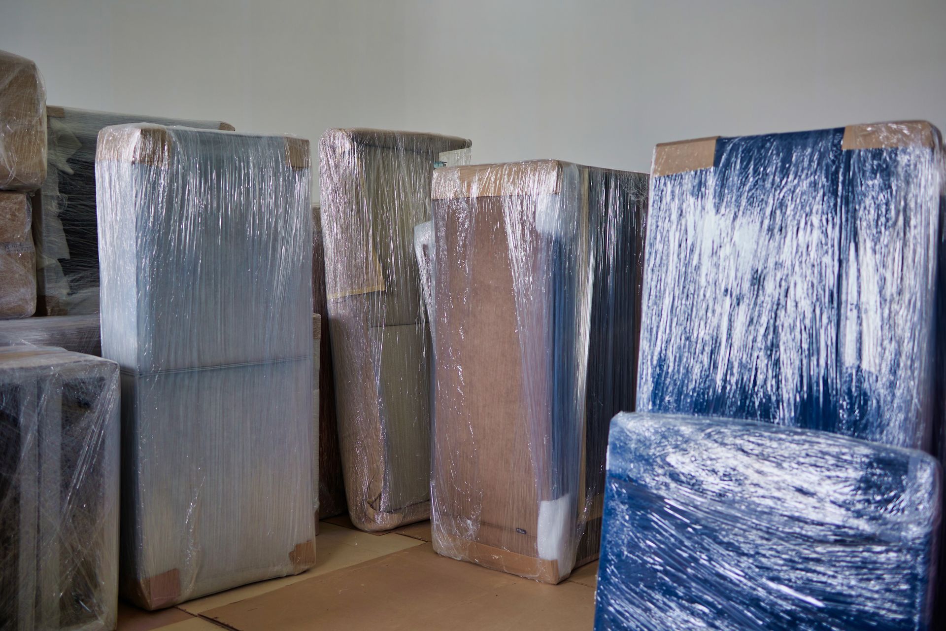 A room filled with boxes wrapped in plastic wrap.