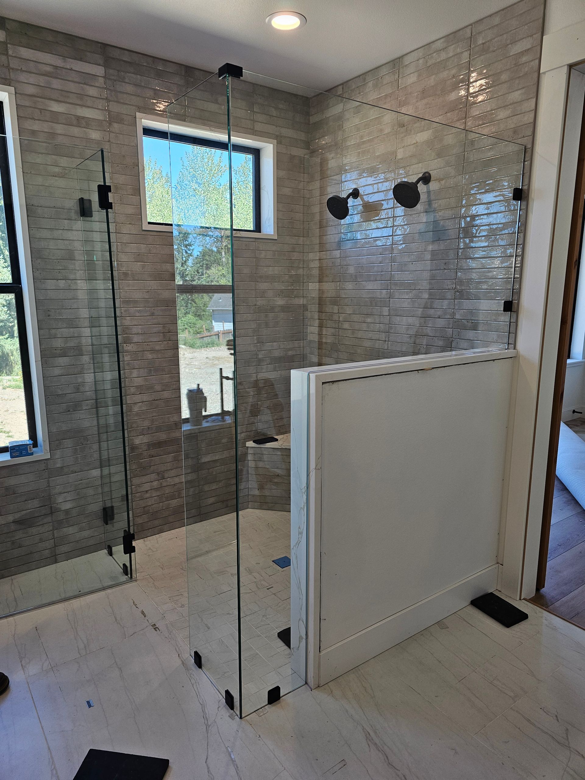Trench dug in a grassy yard, leading to a house with black siding, and an electrical box.
