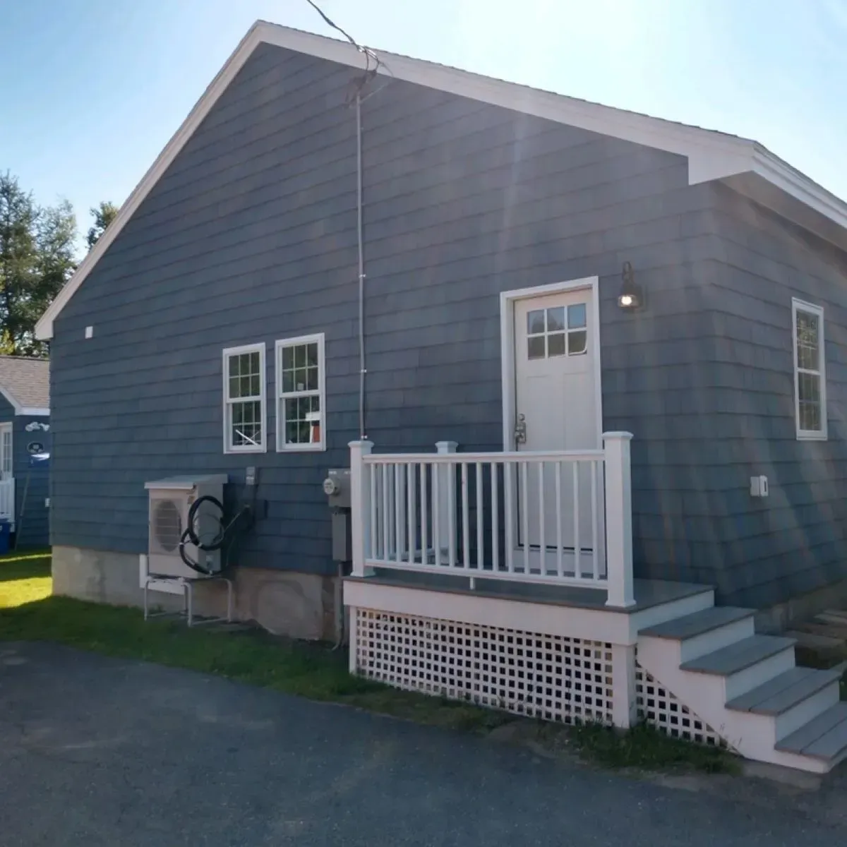 A blue house with a white porch and stairs