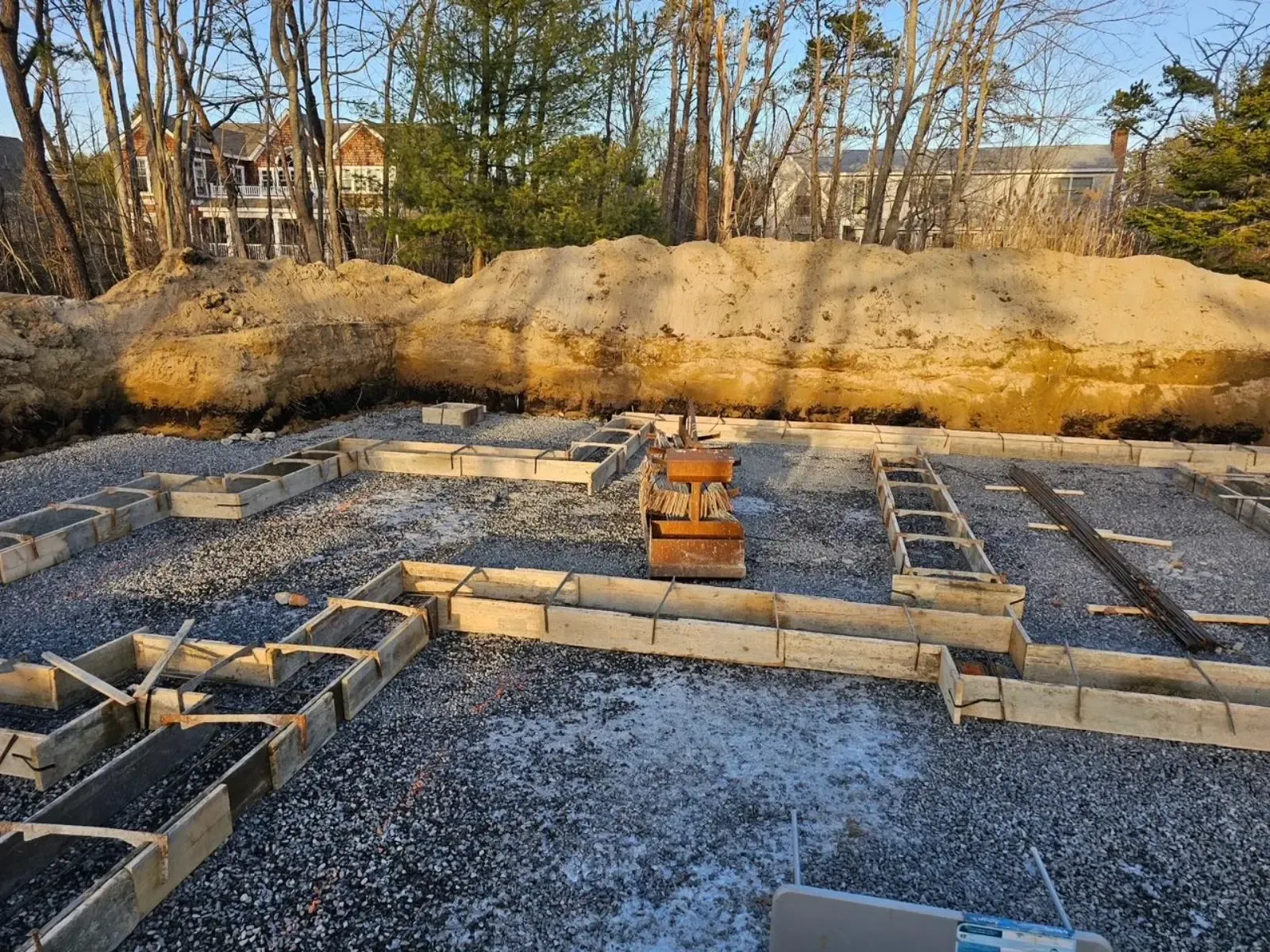 A construction site with a large pile of dirt in the background.