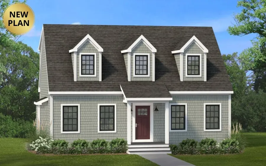 A gray two-story house with a steep roof, three dormer windows, and a front porch, set against a green lawn and trees.