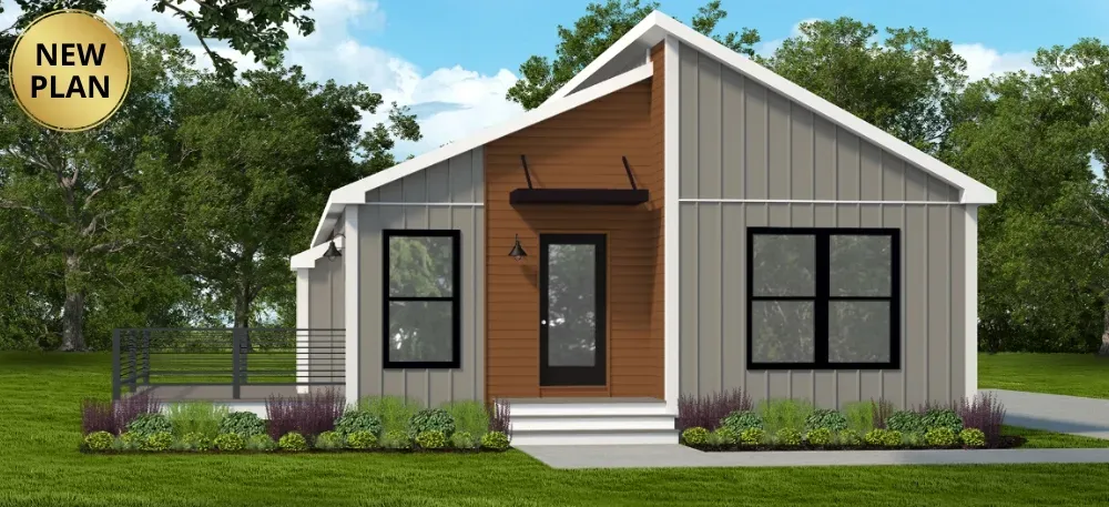 A modern, single-story gray house with a wood-accented entryway, white trim, and a small front deck, set on a green lawn.
