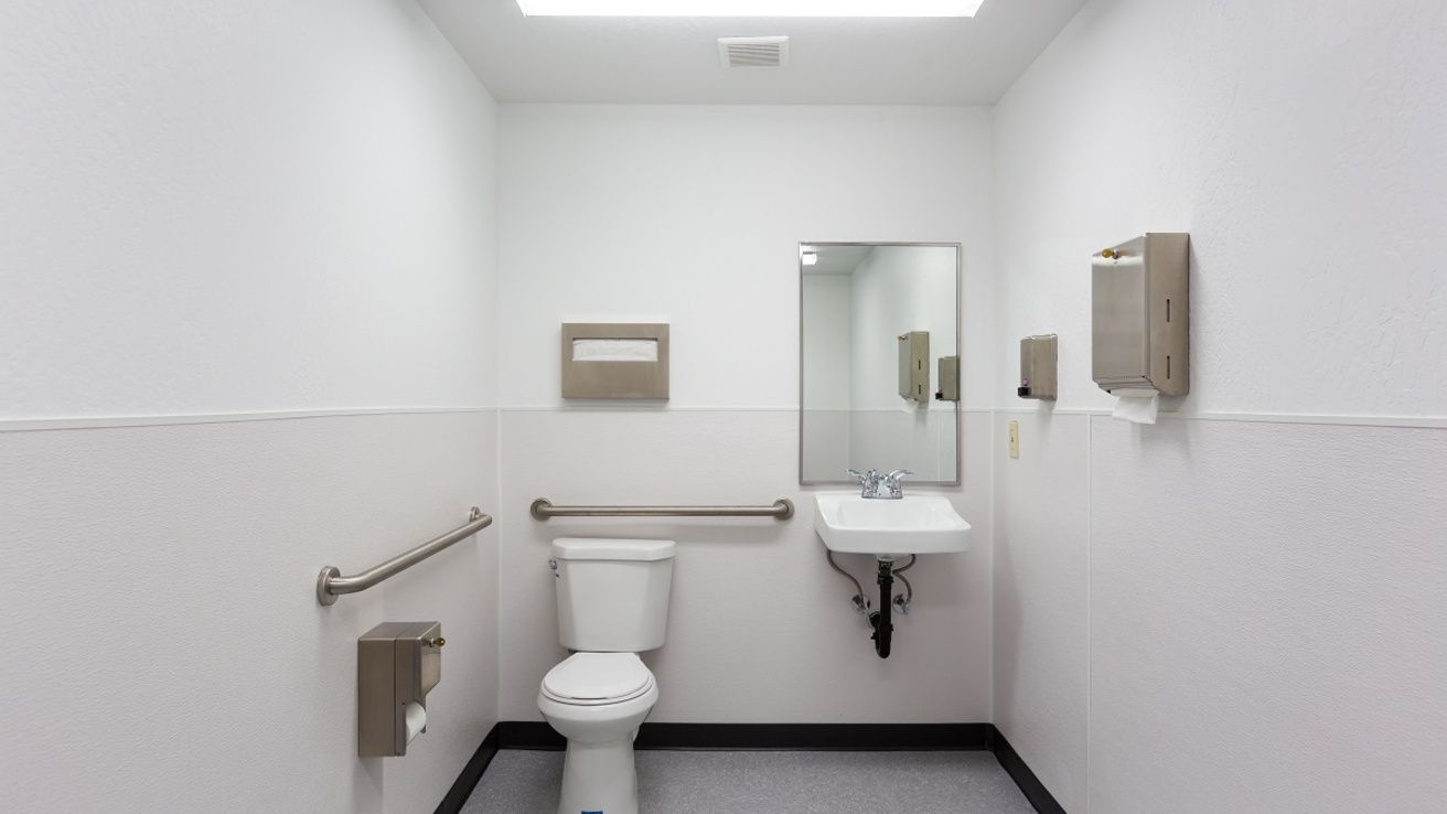 White toilet, lid up, from an overhead view, in a bathroom.