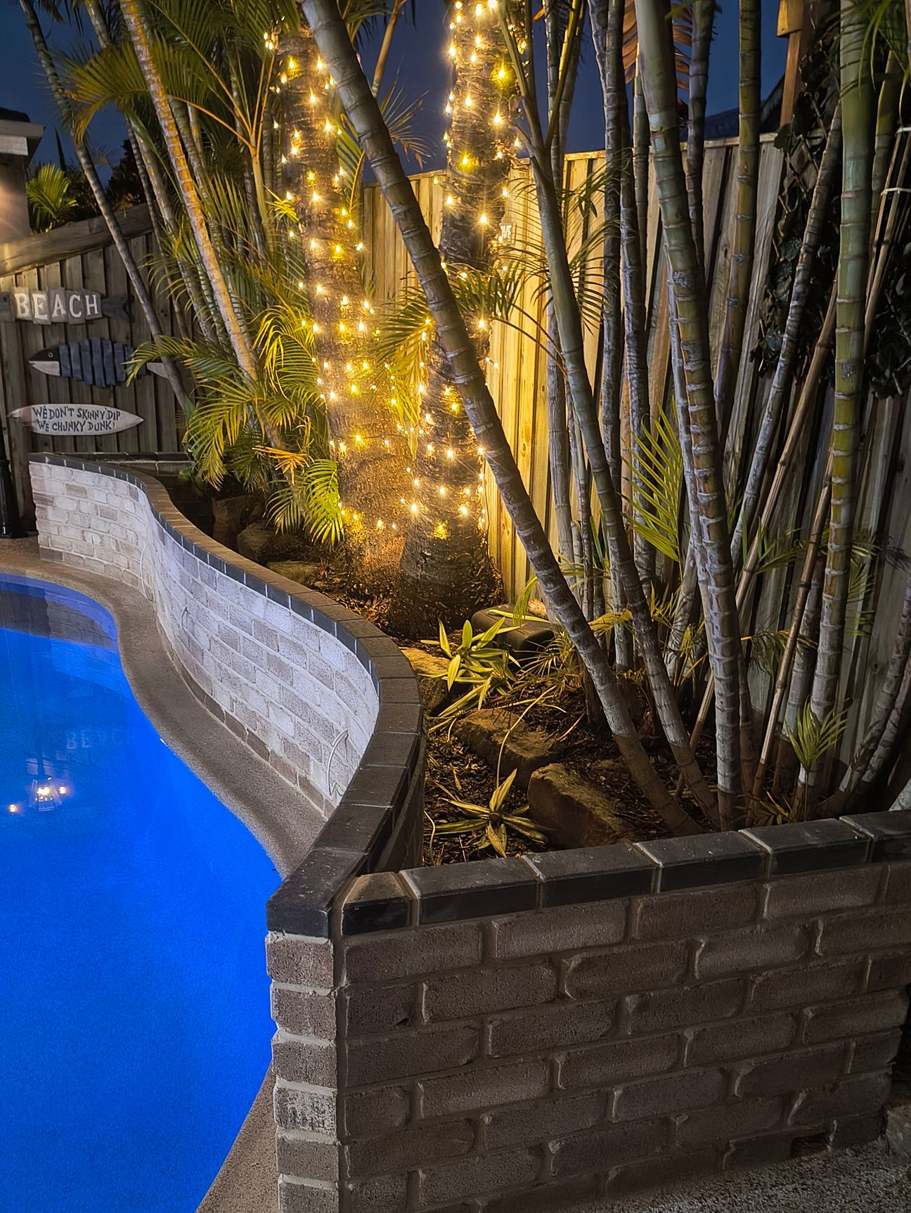 Construction Worker Applying Sealant To Brick Wall — Bricks By Dre In Oxenford, QLD
