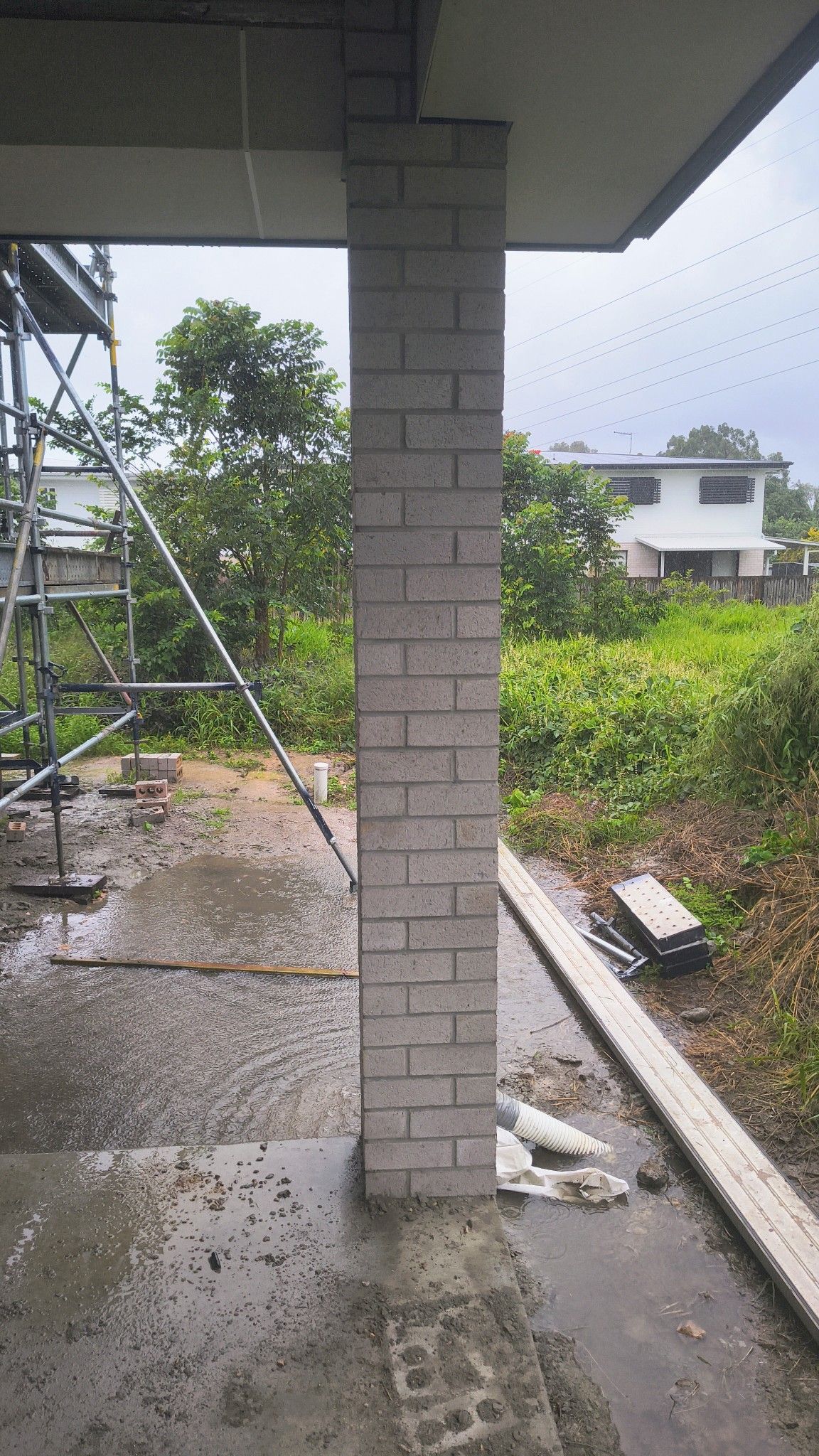 Brick Column Supporting A Building's Overhang On A Rainy Day — Bricks By Dre In Coomera, QLD