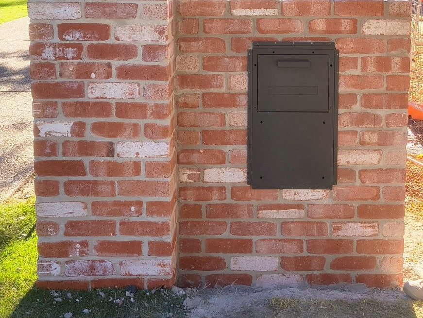 Bricked mailbox with a metal door; a person opening it. Number 4 on the front — Bricks By Dre In Oxenford, QLD