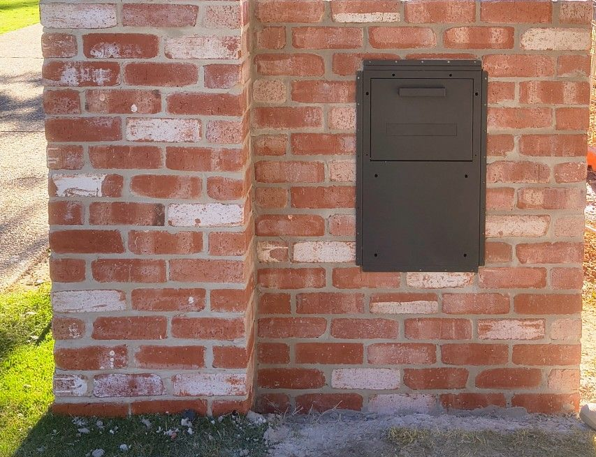 Bricked mailbox with a metal door; a person opening it. Number 4 on the front — Bricks By Dre In Oxenford, QLD