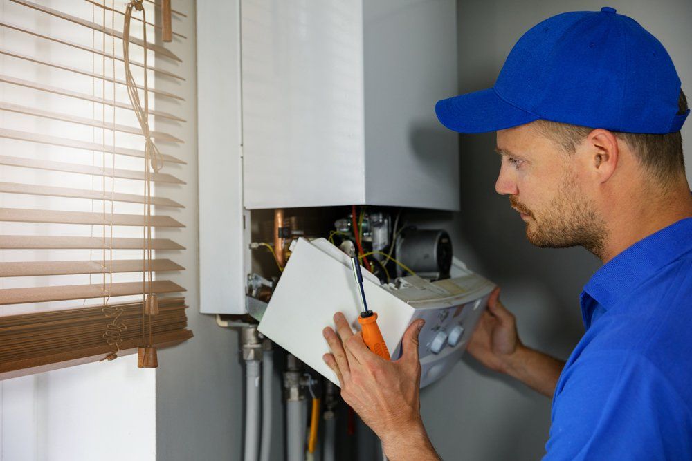 Plumber Checking Water Heater — Land O' Lakes, FL — Optimum Plumbing