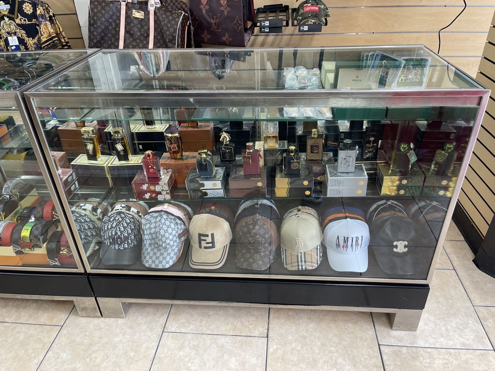Glass display case with hats and perfumes in a store.