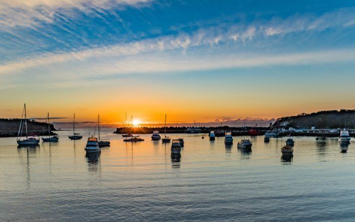 A Group Of Boats Are Docked In A Harbor At Sunset — Sal's Excavations In Ulladulla, NSW
