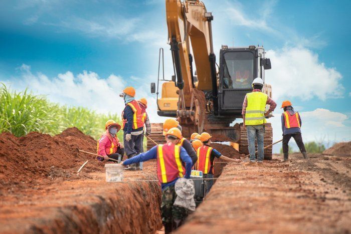 A Group Of Construction Workers Are Working On A Construction Site — Sal's Excavations In Ulladulla, NSW