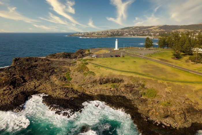 An Aerial View Of A Lighthouse On A Cliff Overlooking The Ocean — Sal's Excavations In Kiama, NSW