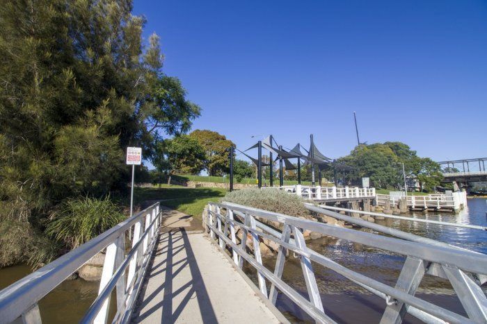 A Bridge Over A Body Of Water With Trees In The Background — Sal's Excavations In Nowra, NSW