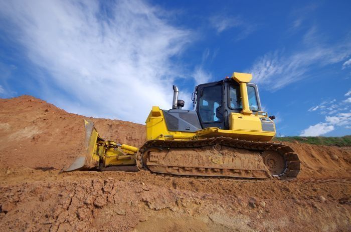 A Yellow Bulldozer Is Sitting On Top Of A Pile Of Dirt — Sal's Excavations In Vincentia, NSW