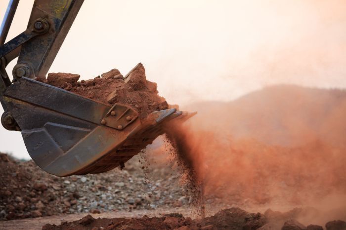 A Bucket Of Dirt Is Being Poured Into A Pile Of Dirt — Sal's Excavations In St. Georges Basin, NSW