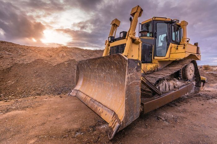 A Bulldozer Is Sitting On Top Of A Dirt Field — Sal's Excavations In St. Georges Basin, NSW
