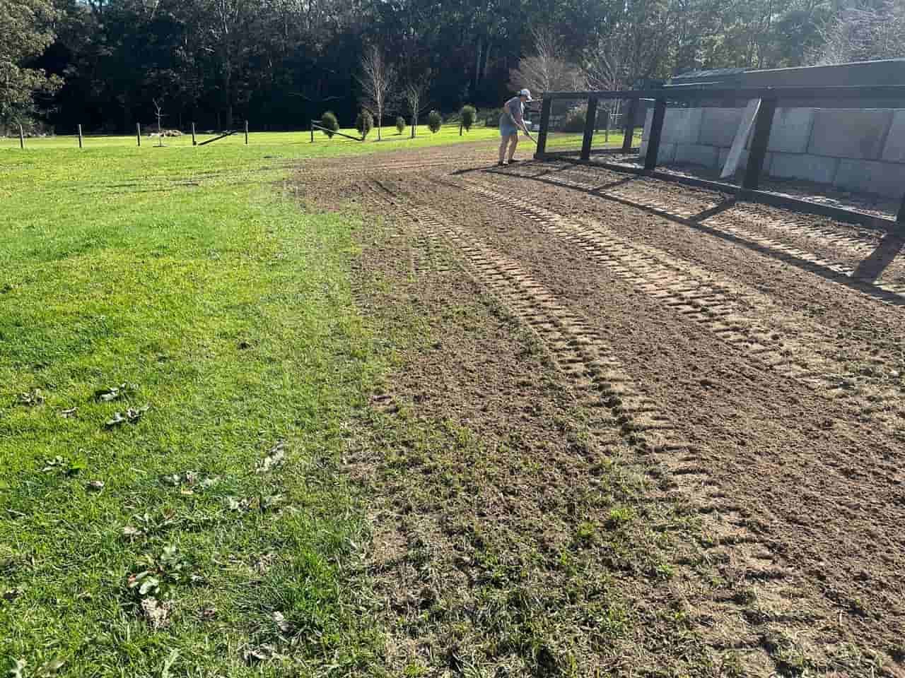 A Dirt Road Going Through A Grassy Field With A Fence — Sal's Excavations In Vincentia, NSW