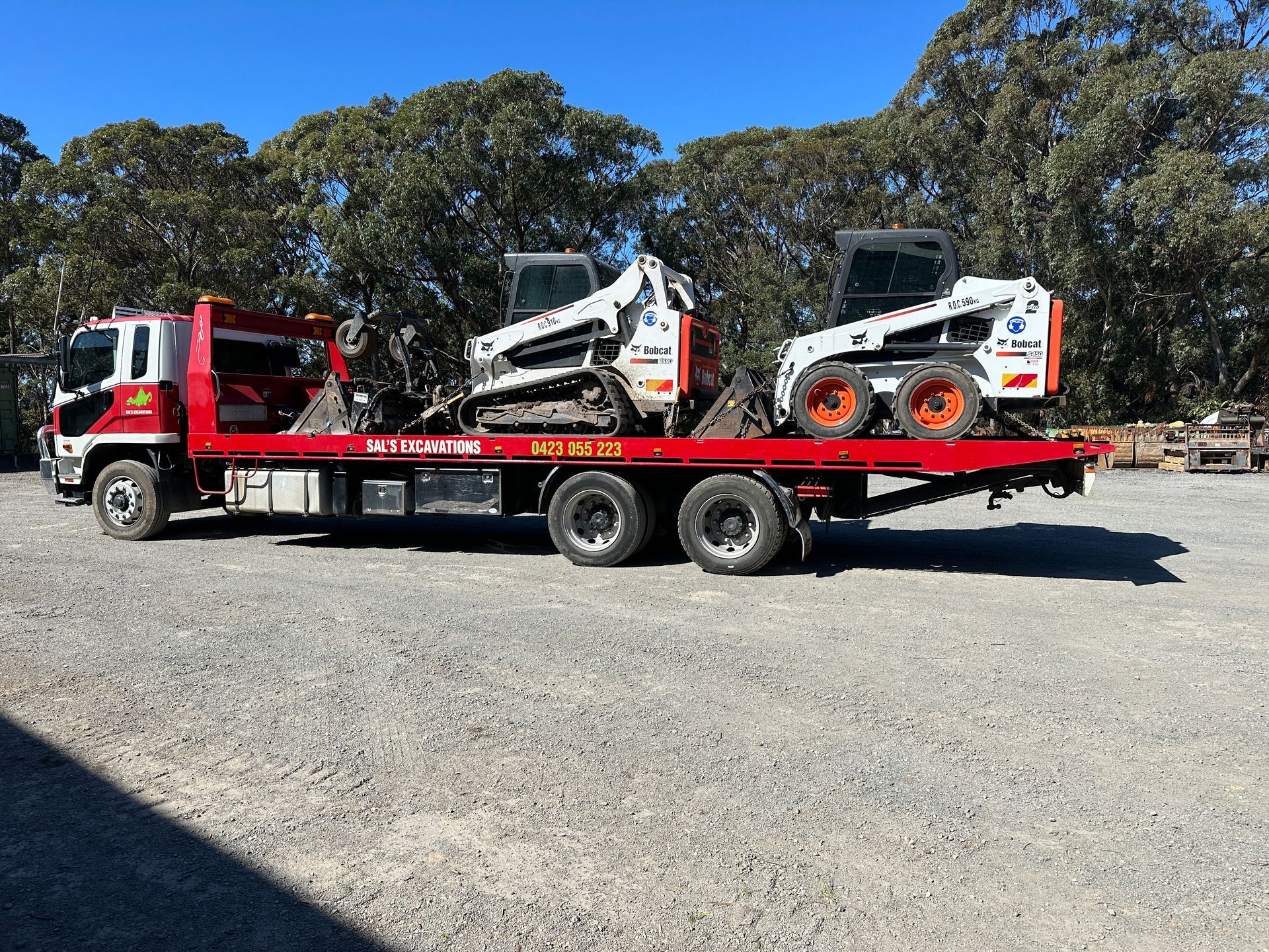 A Yellow Excavator Is Digging A Trench In The Dirt — Sal's Excavations In Falls Creek, NSW