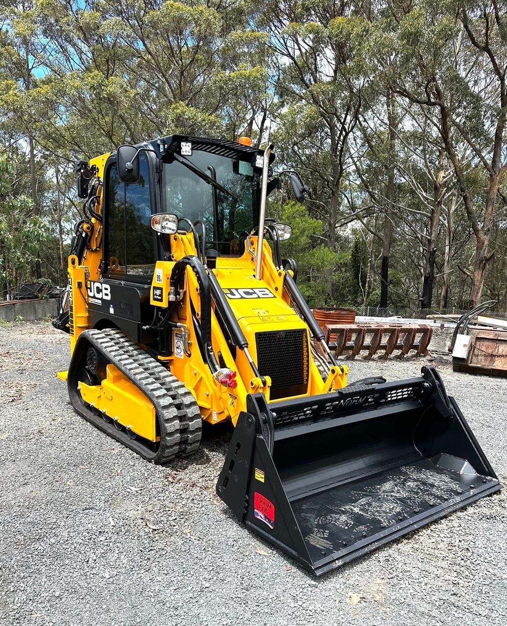 A Group Of Excavators Are Working On A Construction Site At Sunset — Sal's Excavations In Falls Creek, NSW