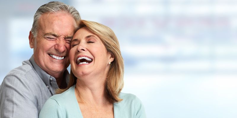 Senior couple smiling — Implant Retained Dentures in Newcastle, NSW