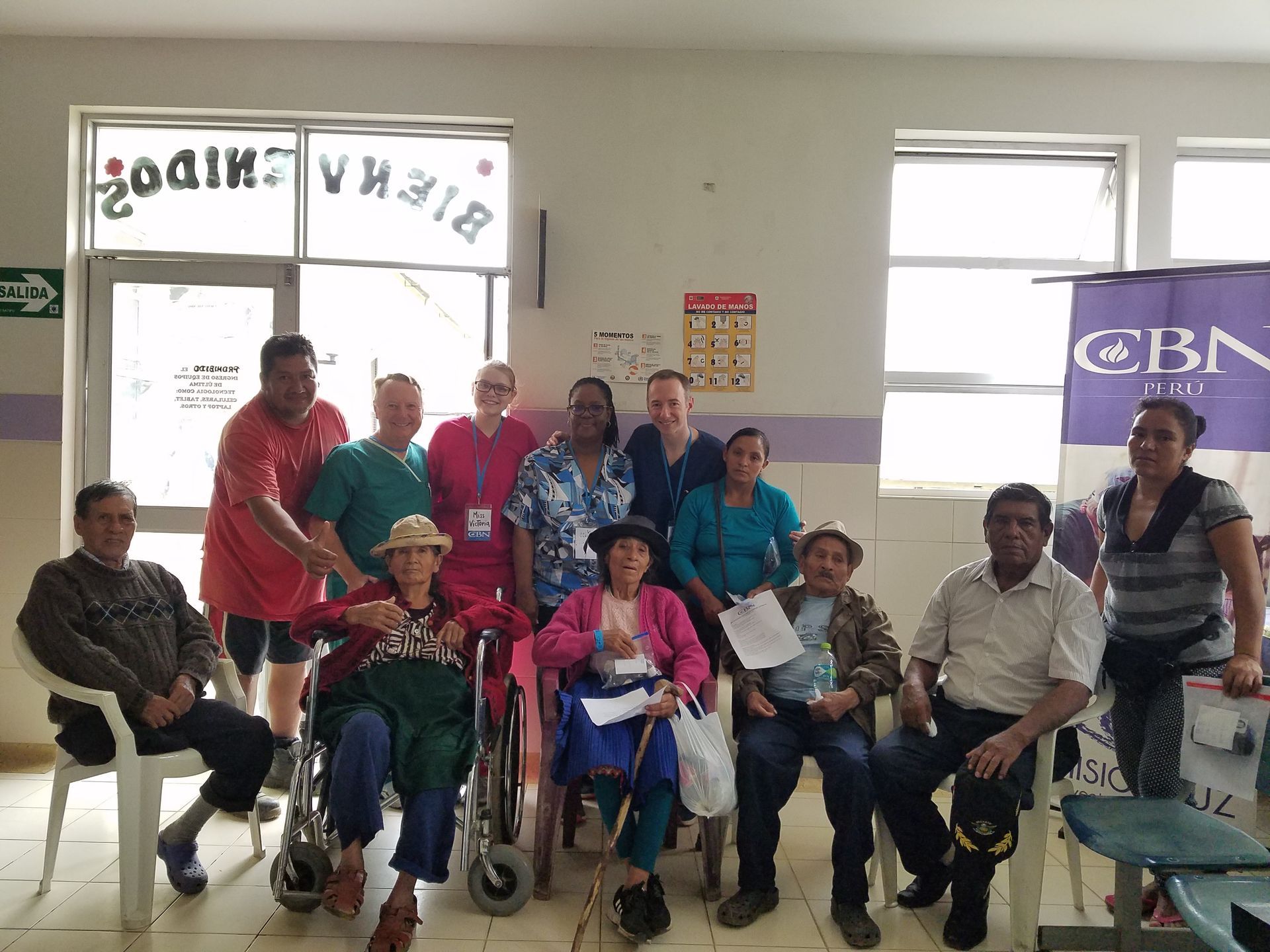 A group of people are posing for a picture in a room.