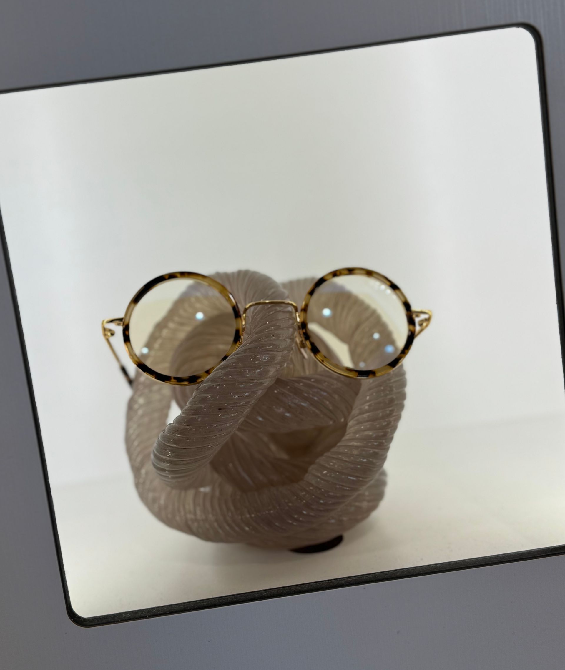 A picture of a statue with glasses on it