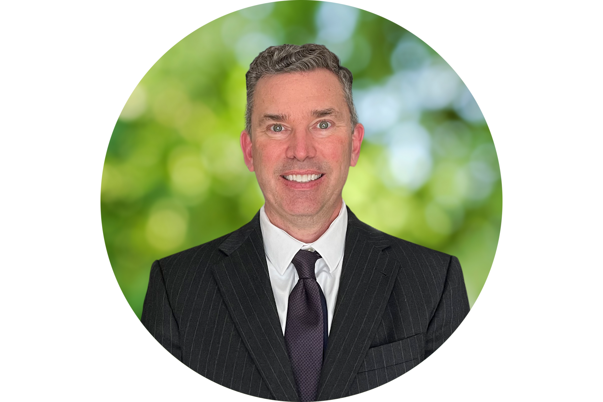 A man in a suit and tie is smiling in a circle.