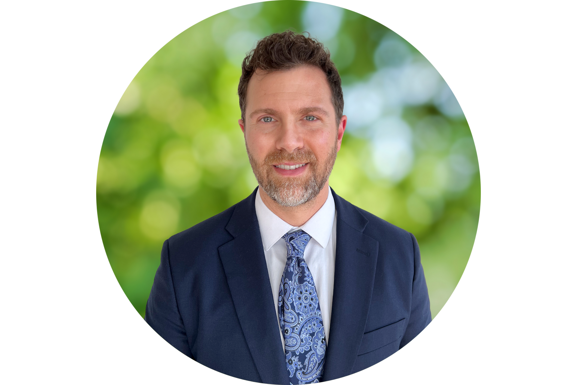 A man in a suit and tie is standing in a circle.