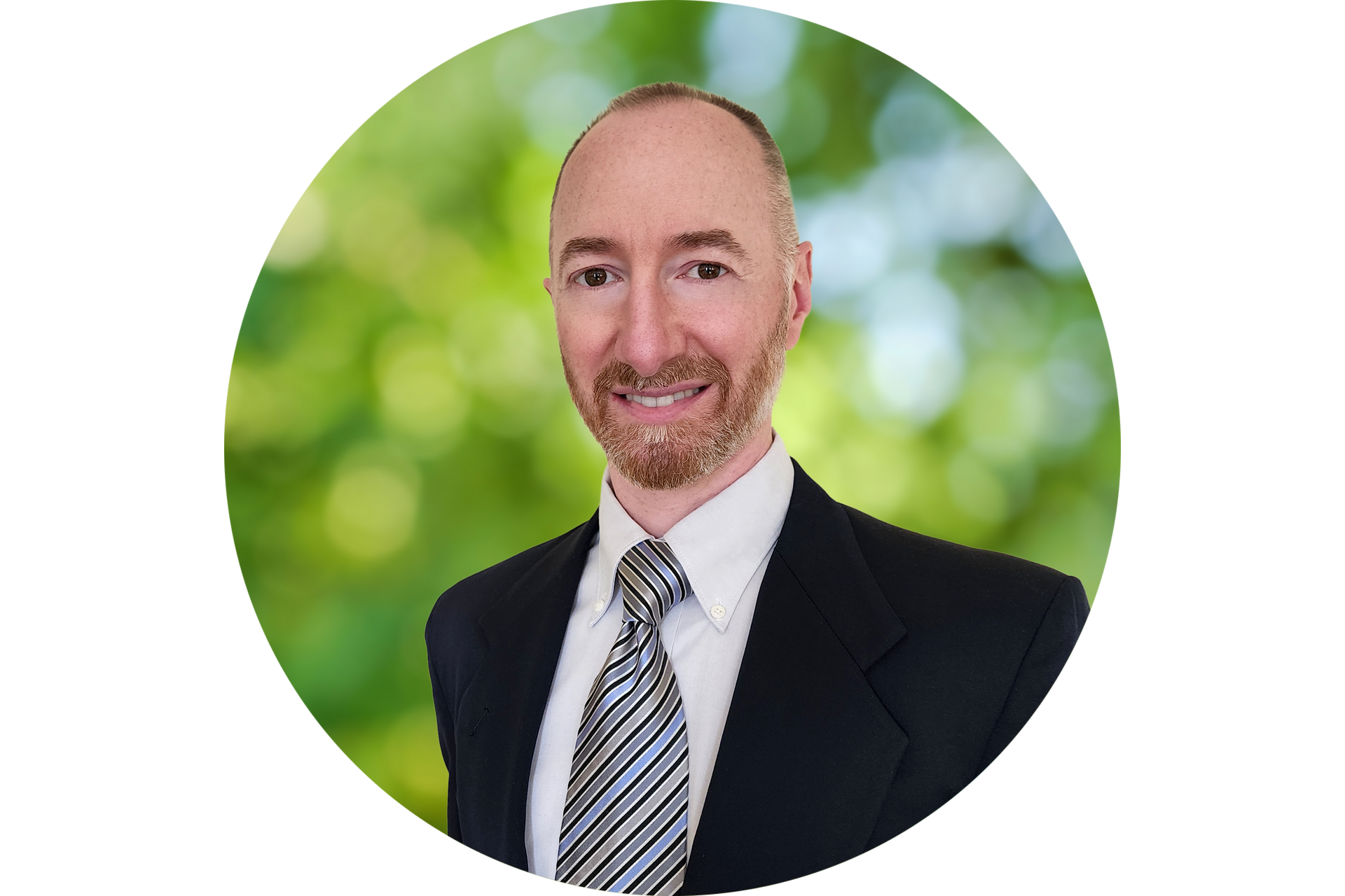 A man in a suit and tie is smiling in a circle.
