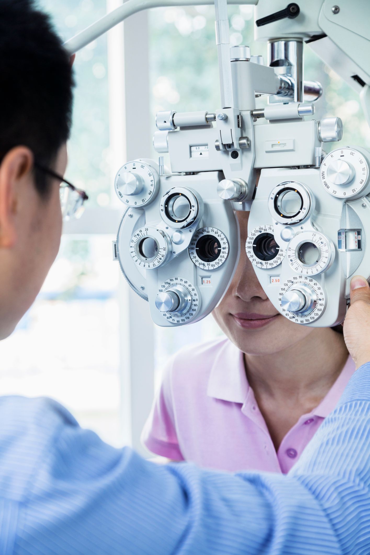 A woman is getting her eyes checked by an ophthalmologist.