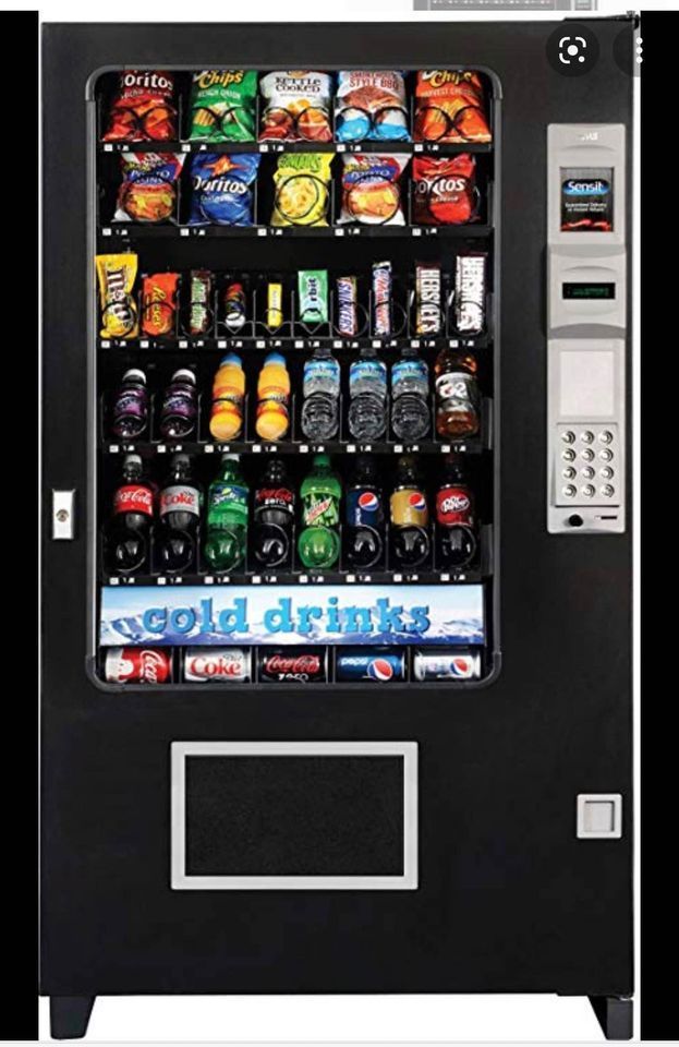 A vending machine that says cold drinks on it