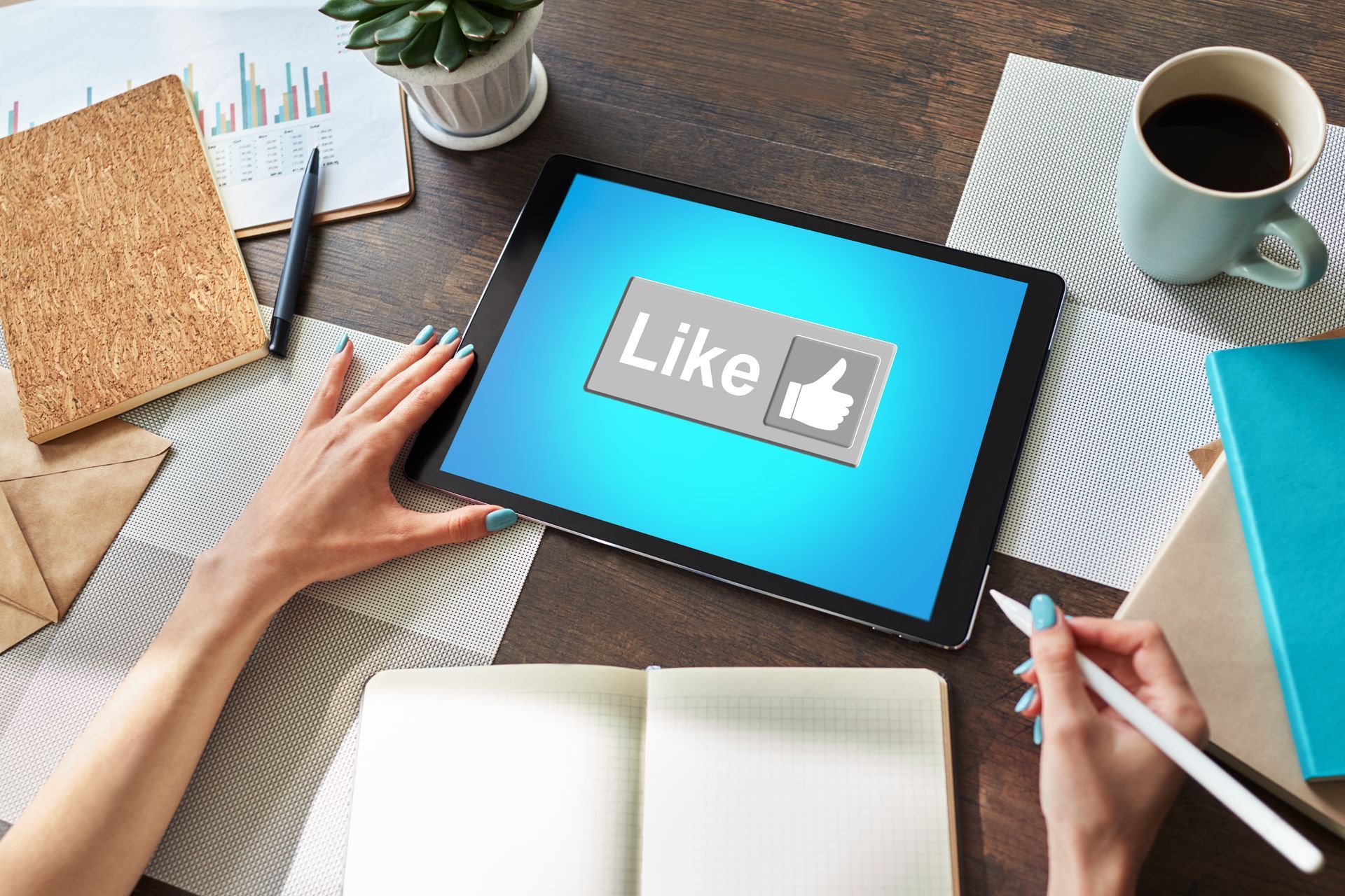 A person is using a tablet with a like button on the screen.
