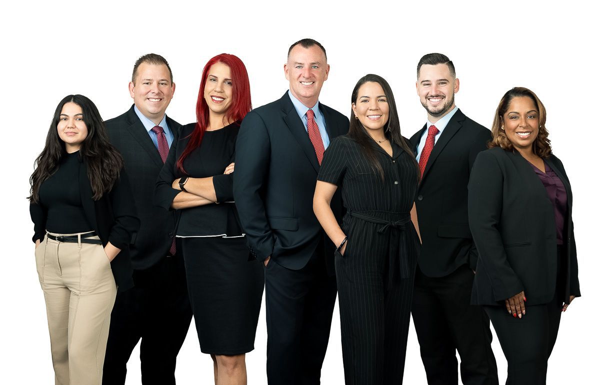 A group of people in suits and ties are posing for a picture.