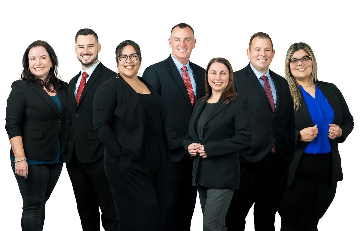 A group of people in suits and ties are posing for a picture.