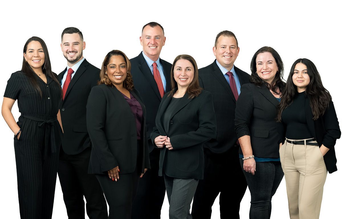 A group of people in suits and ties are posing for a picture.