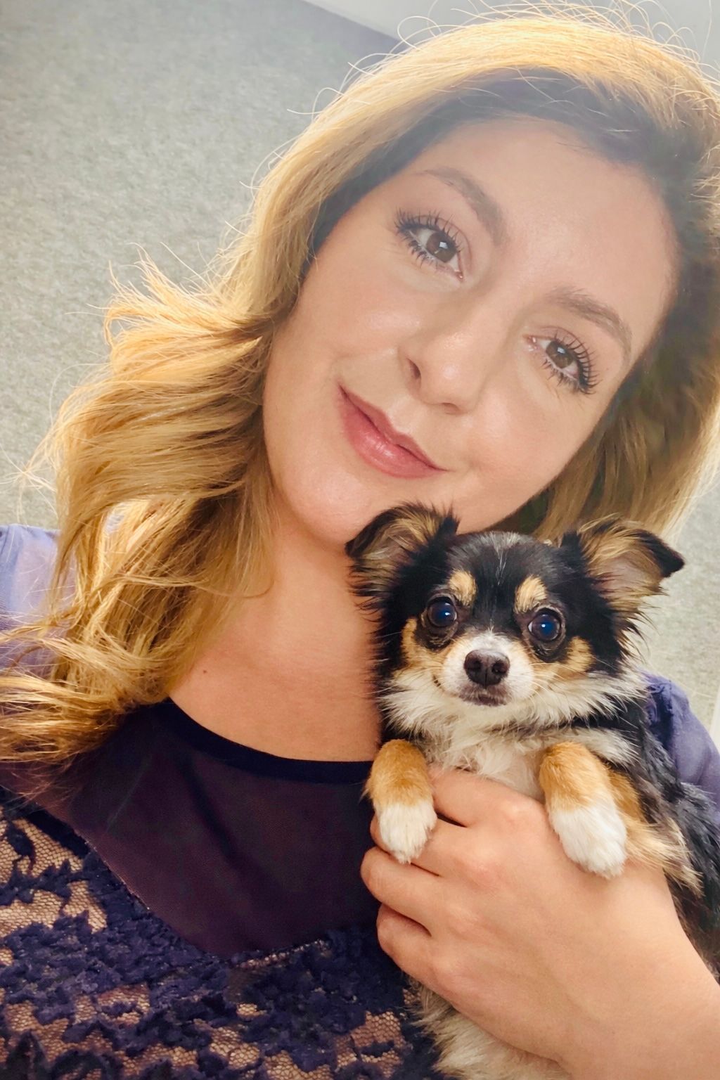 Woman in camouflage sweatshirt and leggings on a train, snowy mountain backdrop.